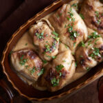 Traditional German Stuffed Cabbage Rolls in a Brown Casserole with a Gravy